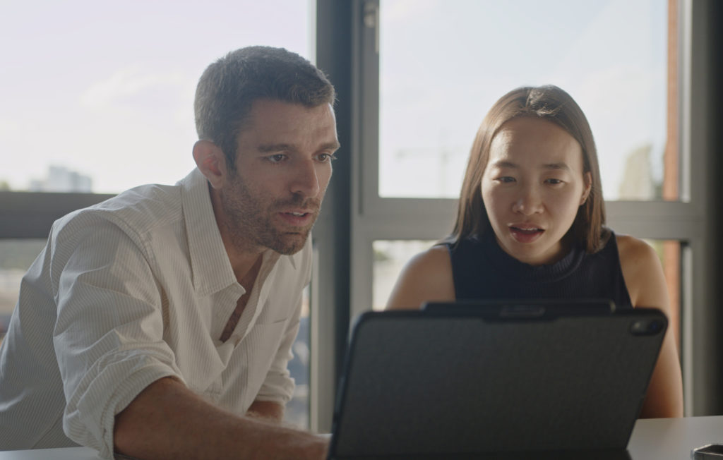 Two people in front of a laptop