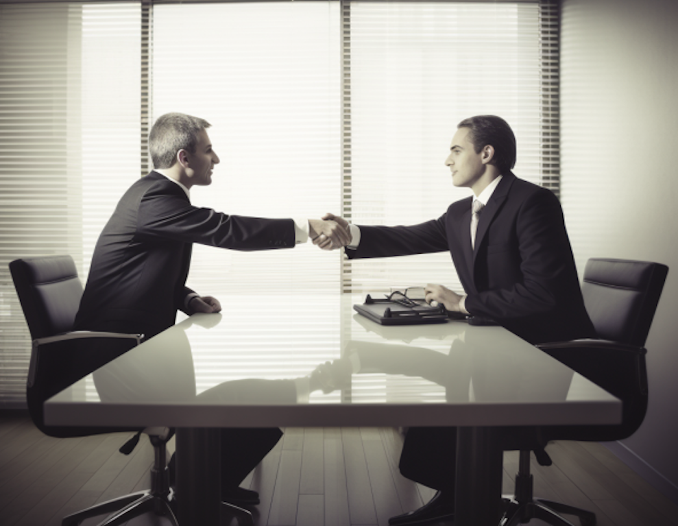 Businessmen shaking hands while seemingly negotiating